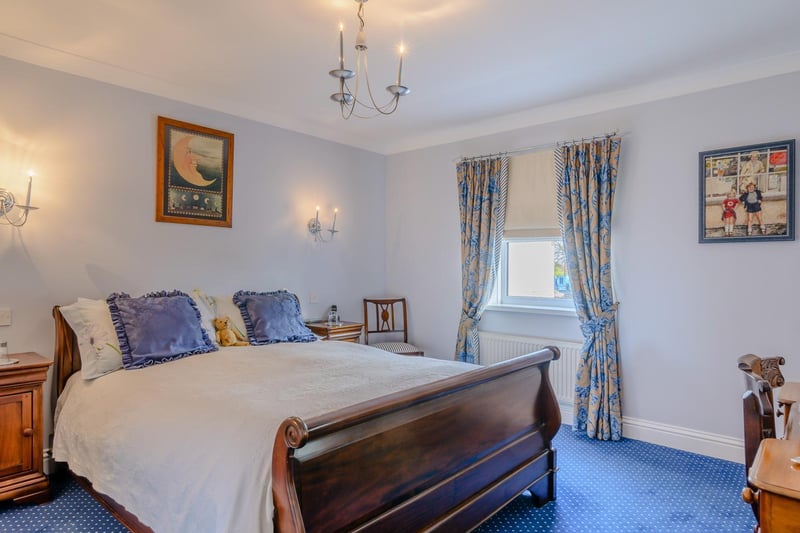 The main bedroom has fitted storage and en-suite with bath and shower.