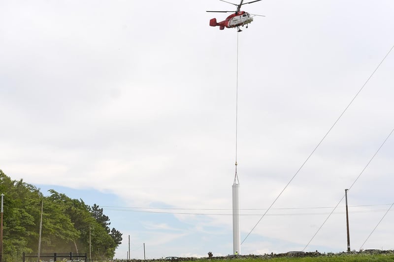 The helicopter picks a part up from the ground