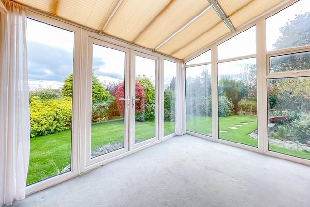 This sun lounge or conservatory with window walls opens out to the gardens.