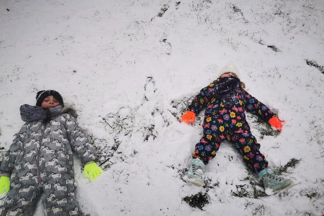 Lily and Aeryn making snow angels by Dani Pettifer