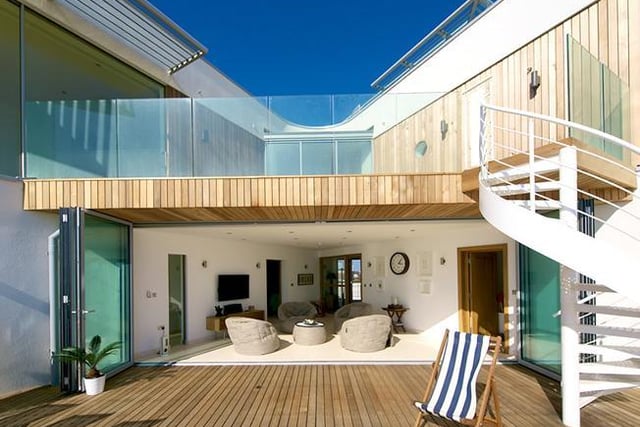 A magnificent award-winning architect-designed beach house with panoramic sea views and private boardwalk to the sands.  It has appeared twice on The Times' list of ‘Britain's 20 Best Beach Houses'.