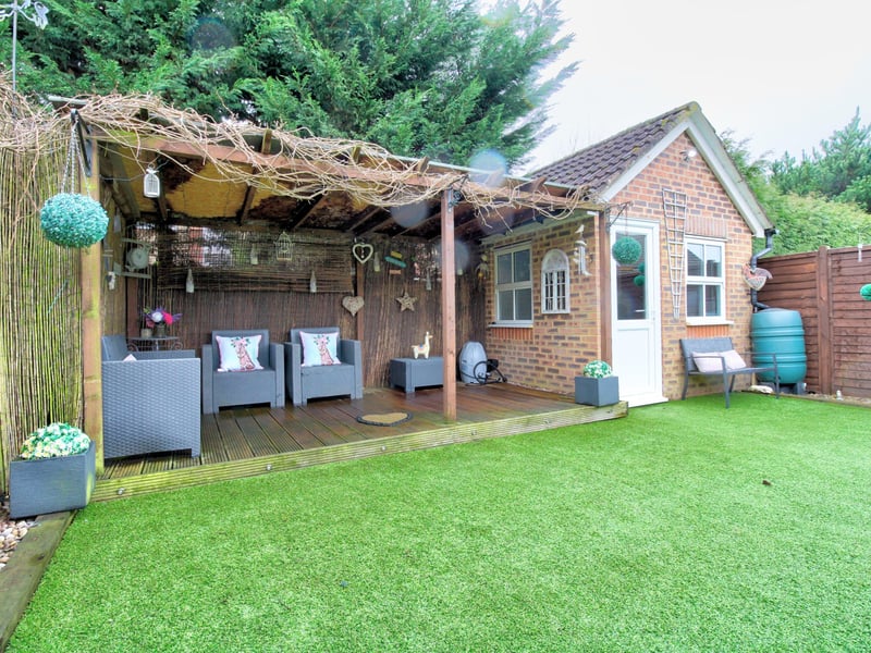 An extended three bedroom end-of-terrace house with a detached home office in the rear garden. Price: £450,000.