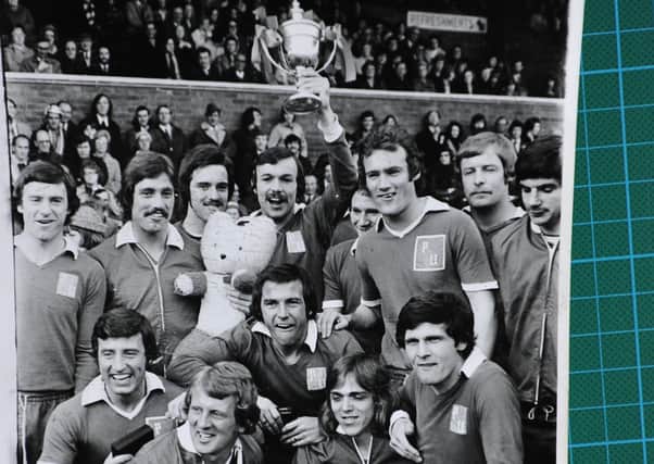 The Posh squad celebrate their 1973-74 Division Four title win. Captain John Cozens is holding teh trophy aloft.