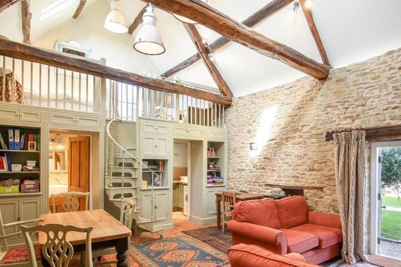 A living room inside the grade II listed property - the Abbey Lodge, which has come up for sale for 1.9m in Farthinghoe (photo from Rightmove)