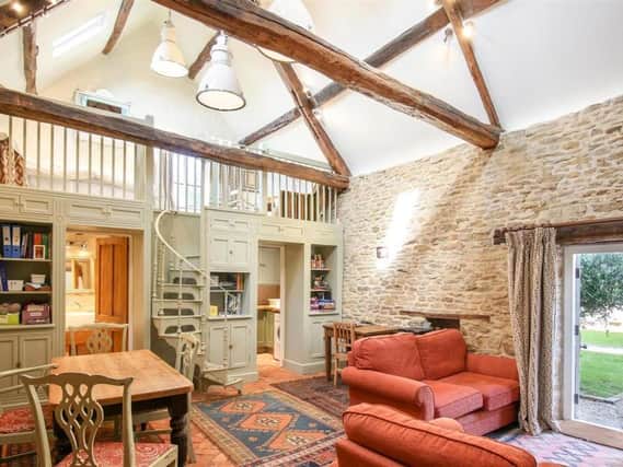 A living room inside the grade II listed property - the Abbey Lodge, which has come up for sale for £1.9m in Farthinghoe (photo from Rightmove)