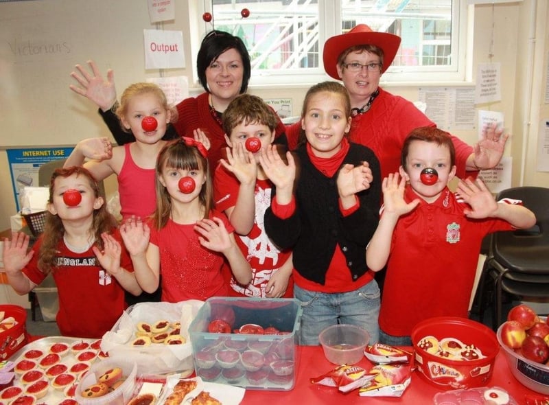 Pupils at the Magdalen School Wainfleet, selling red food and dressed in red.