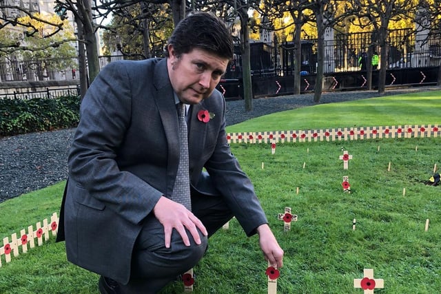 Andrew Lewer laying a poppy in the Constituency Garden of Remembrance at Westminster.