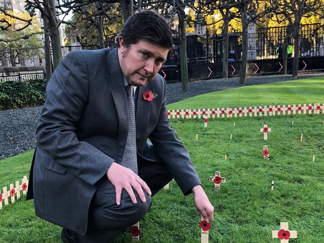 Andrew Lewer laying a poppy in the Constituency Garden of Remembrance at Westminster.