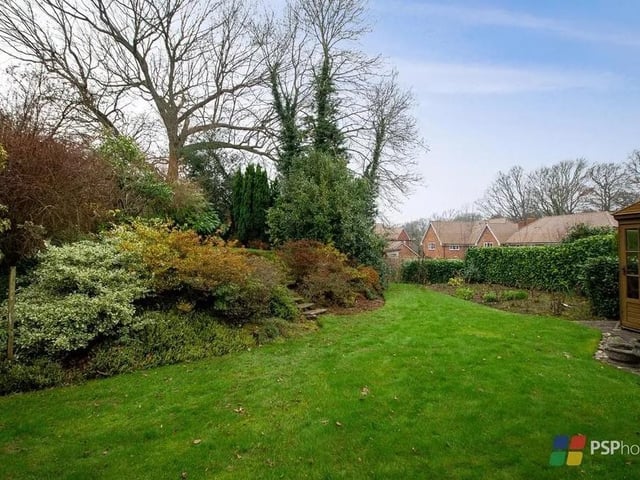 The rear garden enjoys a favoured westerly aspect and there is a paved terrace, expanse of lawn and established borders and beds. Picture: PSP Homes.