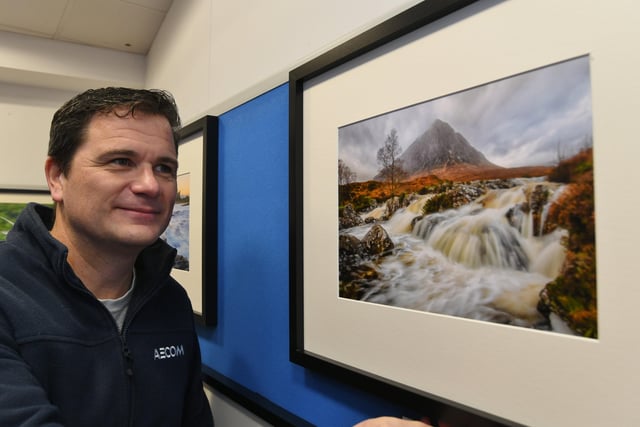 Peterborough Photographic Imaging Co-operative photographic exhibition at Westgate Arcade. Exhibitor Paul Giles with his work. EMN-220122-165239009