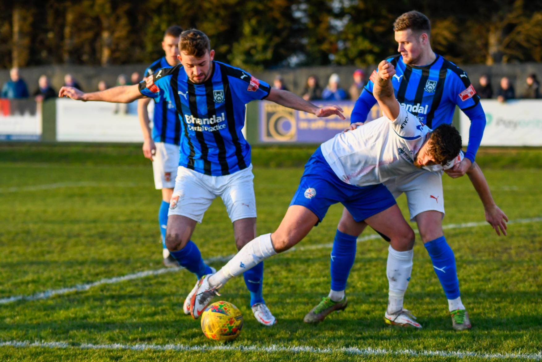 Ty Deacon battles to keep control of the ball