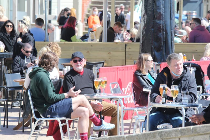 People enjoying drinks by the beach in the sun. Photo: Eddie Mitchell