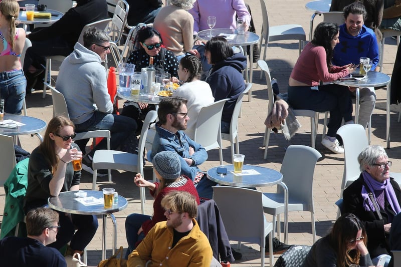People enjoying drinks by the beach in the sun. Photo: Eddie Mitchell