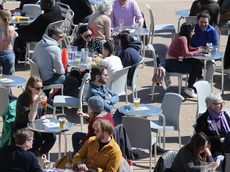 People enjoying drinks by the beach in the sun. Photo: Eddie Mitchell