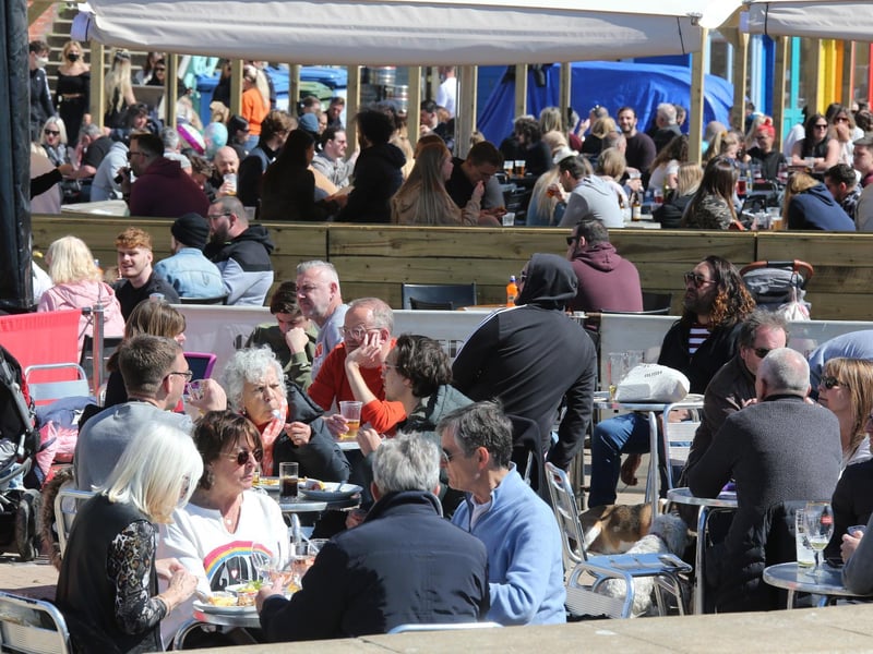 People enjoying drinks by the beach in the sun. Photo: Eddie Mitchell