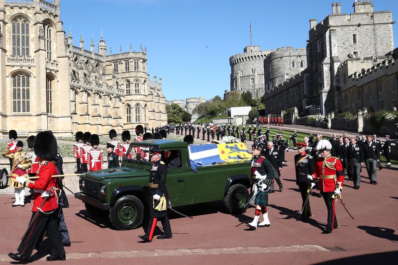 The Duke of Edinburgh's coffin, covered with his personal standard on the Land Rover Defender he helped to design, passes through the Parade Ground, during his funeral at Windsor Castle, Berkshire. Picture PA Wire