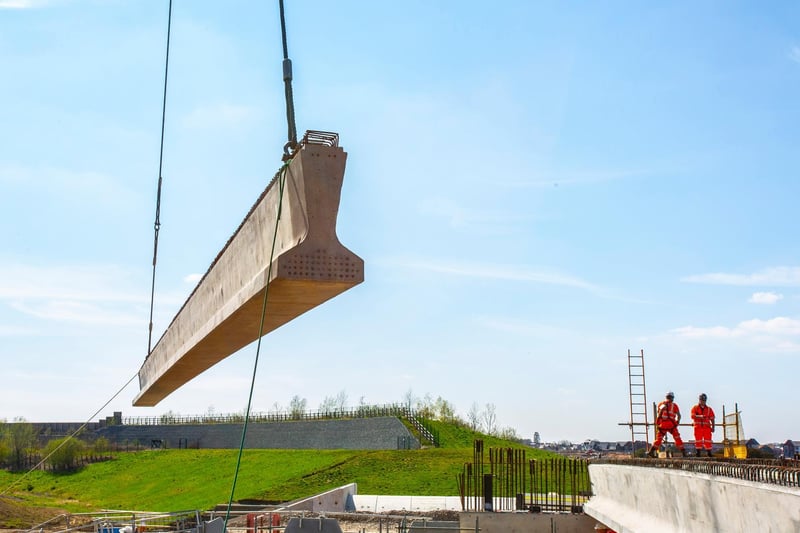 A 50m crane in use installing eight concrete beams for one of three railway link bridges in Northamptonshire.