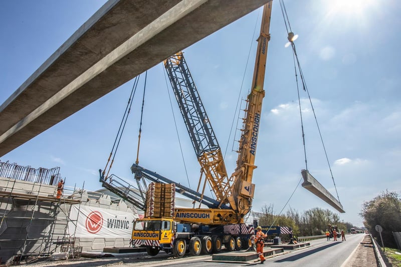 A 50m crane in use installing eight concrete beams for one of three railway link bridges in Northamptonshire.