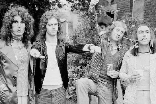 English rock group Slade rose to prominence during the glam rock era in the early 1970s. Left to right: drummer Don Powell, bassist Jim Lea, singer Noddy Holder and guitarist Dave Hill. (Photo by Michael Putland/Getty Images)