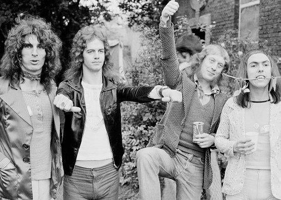 English rock group Slade rose to prominence during the glam rock era in the early 1970s. Left to right: drummer Don Powell, bassist Jim Lea, singer Noddy Holder and guitarist Dave Hill. (Photo by Michael Putland/Getty Images)