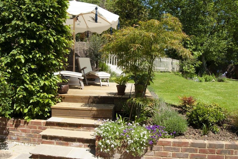 The garden is well-stocked with plants, shrubs and specimen trees. Photo: Zoopla