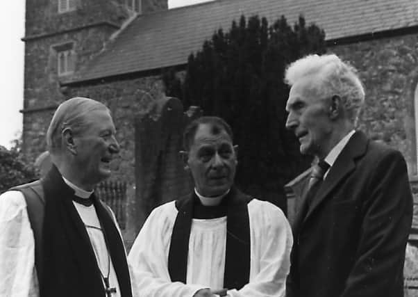 The Bishop of Connor, Dr Arthur Butler, left, celebrated Holy Communion in St Saviour’s Church, Connor, Co Antrim, in September 1980, on the 1,500th anniversary of the founding of the church. He is seen speaking to the oldest member of the parish, Mr Francis Hoey, who would turn 80 in January 1981. Included is the rector, the Rev Adrian S Hofmeester. Picture: News Letter archives