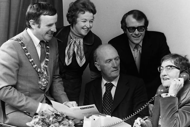 Lord Mayor of Belfast, Alderman John Carson, who officially opened the Information and Advice Centre for Age Concern in September 1980,  looks on as voluntary helper Mary Cowan answers a call at the premises in Great Victoria Street. Included are other helpers, Patrick Murray, Jean Currie and Bob Byers. Picture: News Letter archives