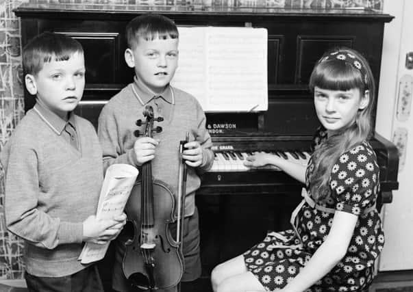 1969 - Eleven-years-old Anne McCloskey won both the junior piano (10-12 years) and girls' vocal solo (10-12 years) competitions at Feis Doire Colmcille. She's pictured here with her brothers, John (10), on left, who was among the bursary award winners in the violin classes, and Francis (9), who was a third prizewinner in the violin (under 10 years).