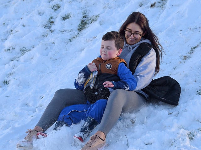 Jacob Simpson, aged 6, and Jayne McSherry slide in the snow at the Creggan Burn on Saturday morning last. Photo: George Sweeney / Derry Journal. DER2104GS – 020