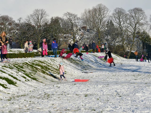 Families enjoy the sunshine and snow in Brooke Park on Saturday afternoon last. Photo: George Sweeney / Derry Journal. DER2104GS – 027