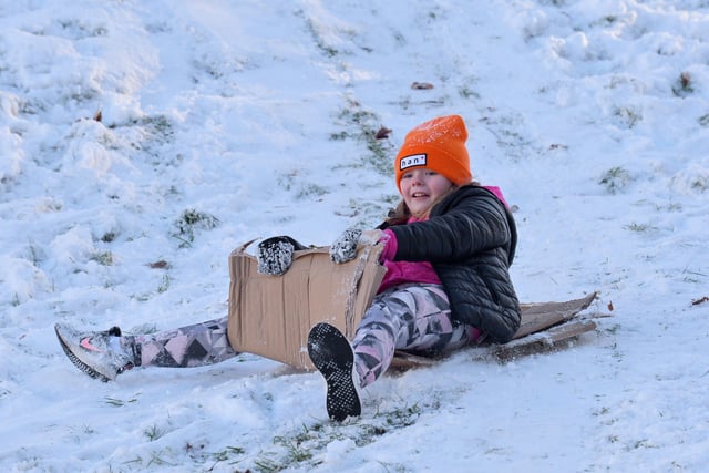 Katie McElhinney, aged 10, having fun in the snow at the Creggan Burn on Saturday morning last. Photo: George Sweeney / Derry Journal.  DER2104GS – 017