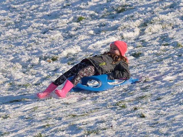 Enjoying sliding the snow, on the banking overlooking the Bogside, on Saturday afternoon last. Photo: George Sweeney / Derry Journal. DER2104GS – 037