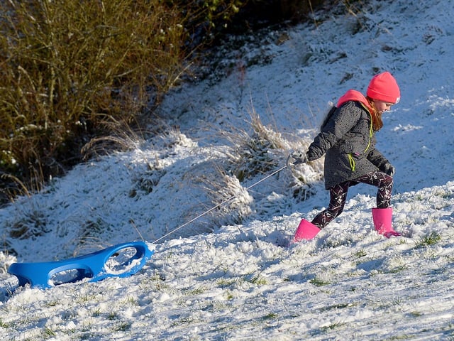 It a long way to the top for a slide on the snow covered banking overlooking the Bogside, on Saturday afternoon last. Photo: George Sweeney / Derry Journal. DER2104GS – 038