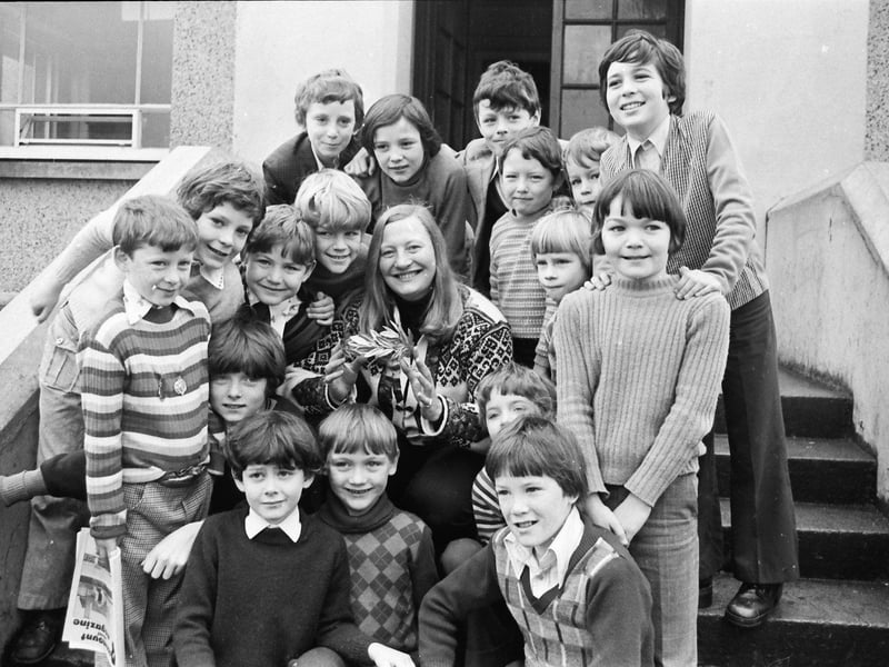 Olympic pentathlon champion Mary Peters pictured with young athletes during a visit to Rosemount Primary School.