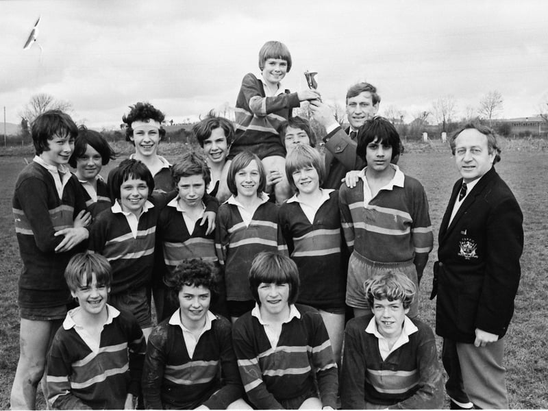Willie John McBride, former captain of the Irish and Lions rugby teams, presenting the trophy to Keith Hegarty, captain of the Foyle College team which won the City of Derry Rugby Club's under-13 competition for secondary schools held at the club grounds at Buncrana Road. Included, on right, is president of the club, Ted Maxwell.