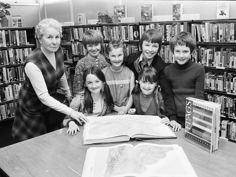 Children from Carnhill PS using reference books at the library. At front, Deirdre Harley (left) and Noelle Mottram. At back, from left, Anna Peoples, library assistant in charge, Ciaran O'Donnell, Christine Hurford, Richard Boyle and Bernard Hasson.