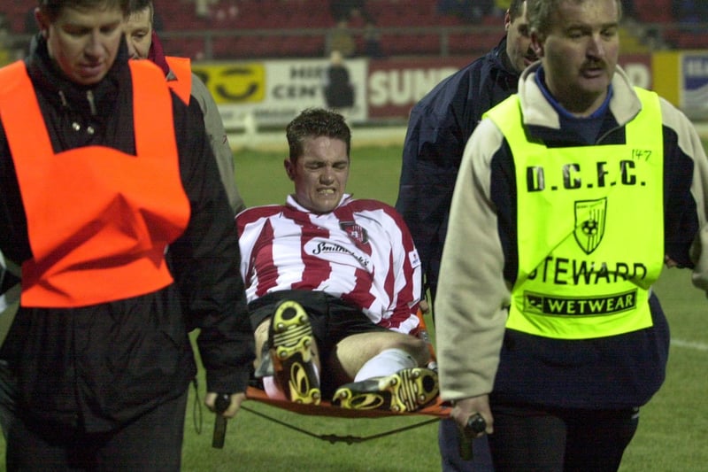 Derry City striker Gary Beckett is carried off the pitch on a stretcher after sustaining knee ligament damage against Longford Town.