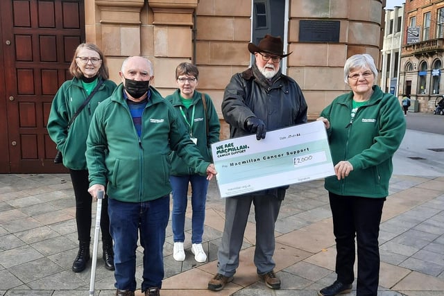 Caring Caretaker Davy Boyle presents John Dunlop, Mildred McMullan, Joanne Browne and Laurene Moore of Macmillan Cancer Support with a cheque for £2,000