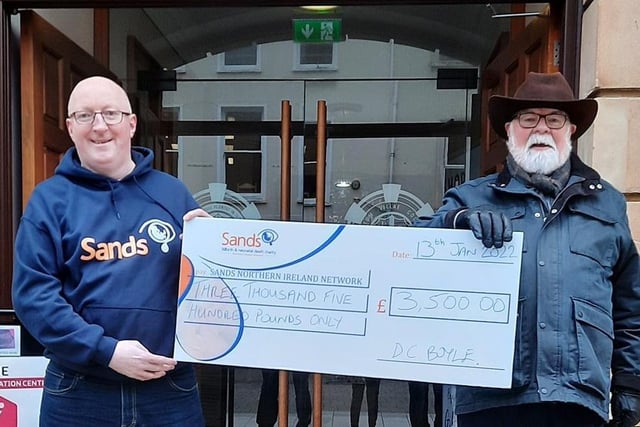 Caring Caretaker Davy Boyle presents Steven Guy of SANDS NI with a cheque for £3,500