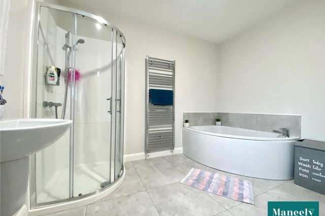 The bathroom has a corner bath and separate shower pod with power shower.