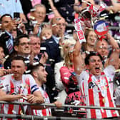 Luke O'Nien of Sunderland celebrates with the Sky Bet League One play-off trophy following victory against Wycombe Wanderers.