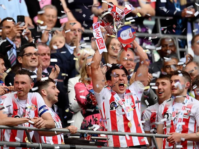 Luke O'Nien of Sunderland celebrates with the Sky Bet League One play-off trophy following victory against Wycombe Wanderers.