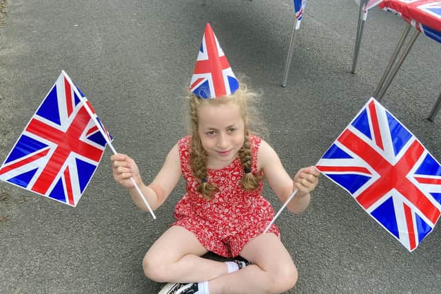 Emily Dyer (8)) with her flags and hat at the Queen's Jubilee celebrations, Fairburn Avenue