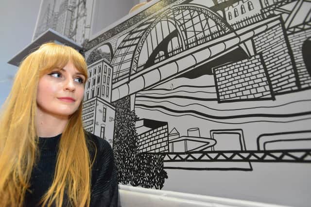 Artist Kathryn Robertson with her latest Mural in the Roker End Cafe. Picture by FRANK REID