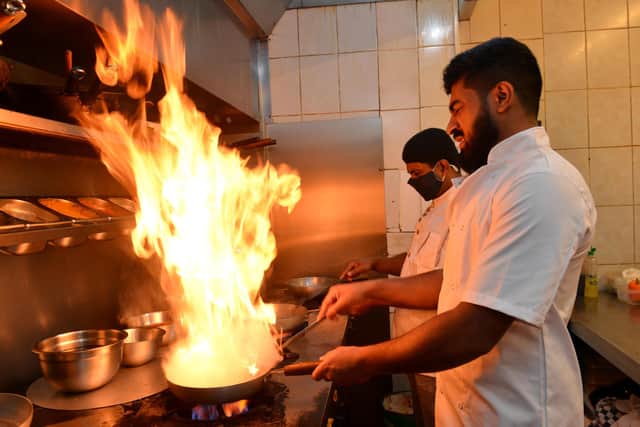 Owner chef Hussain of Rasoi Indian Kitchen takeaway takes on the new premises on Hylton Road with the help of chef Syed Miah (back).