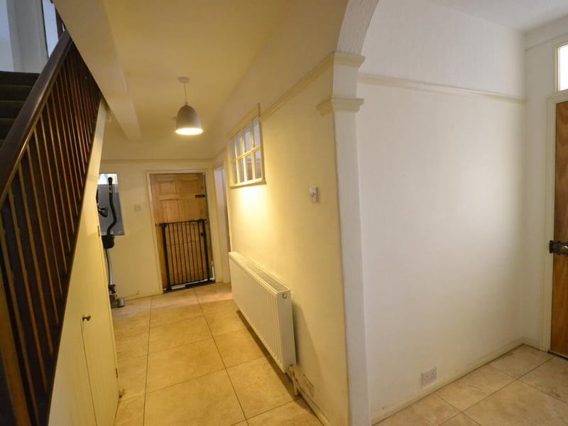 The hall features attractive Travertine tiled flooring.