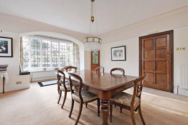 The formal dining room has a box bay window with garden views, a side window and feature fireplace with ornate wood surround and living flame gas fire inset. There is a built in display cabinet and a further side facing window.