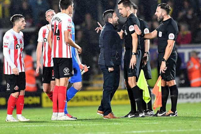 Sunderland head coach Lee Johnson with the officials after the loss to Burton Albion