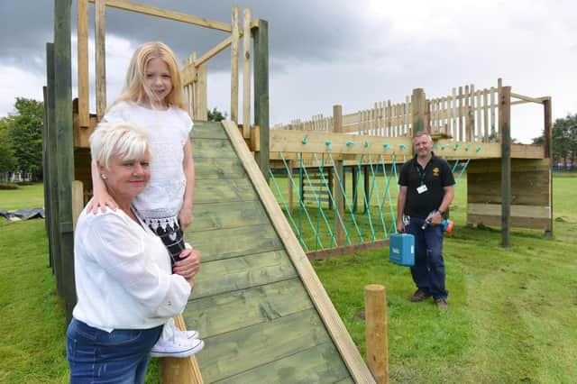 Work is almost done on the castle play area by John Murray and his team of helpers thanks to a donation and fundraising efforts by Angie Crosbie, pictured with her granddaughter Patience, eight.