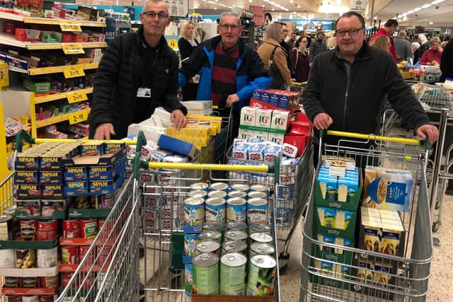 Staff from Age UK Sunderland left to right, Colin Thompson, Brian Pugh and Gordon Phillipson fill trollies ready to put together survival packs for the elderly.